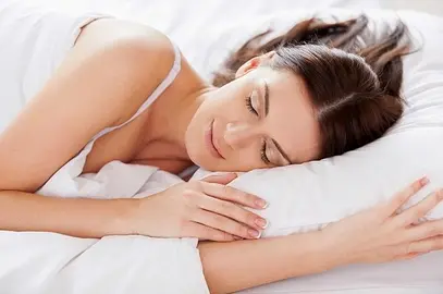 Woman sleeping. Beautiful young woman sleeping while lying in bed 