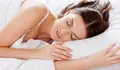 Woman sleeping. Beautiful young woman sleeping while lying in bed 